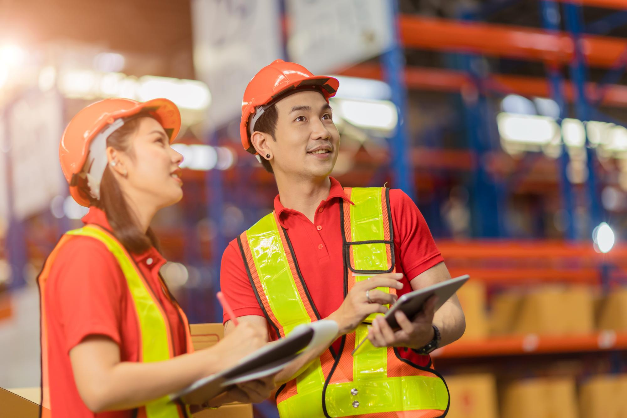 Archer Venture warehouse team reviewing inventory on a tablet